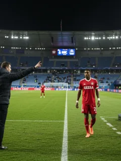 Coach making a game-changing substitution gesture during a European football match under stadium lights.